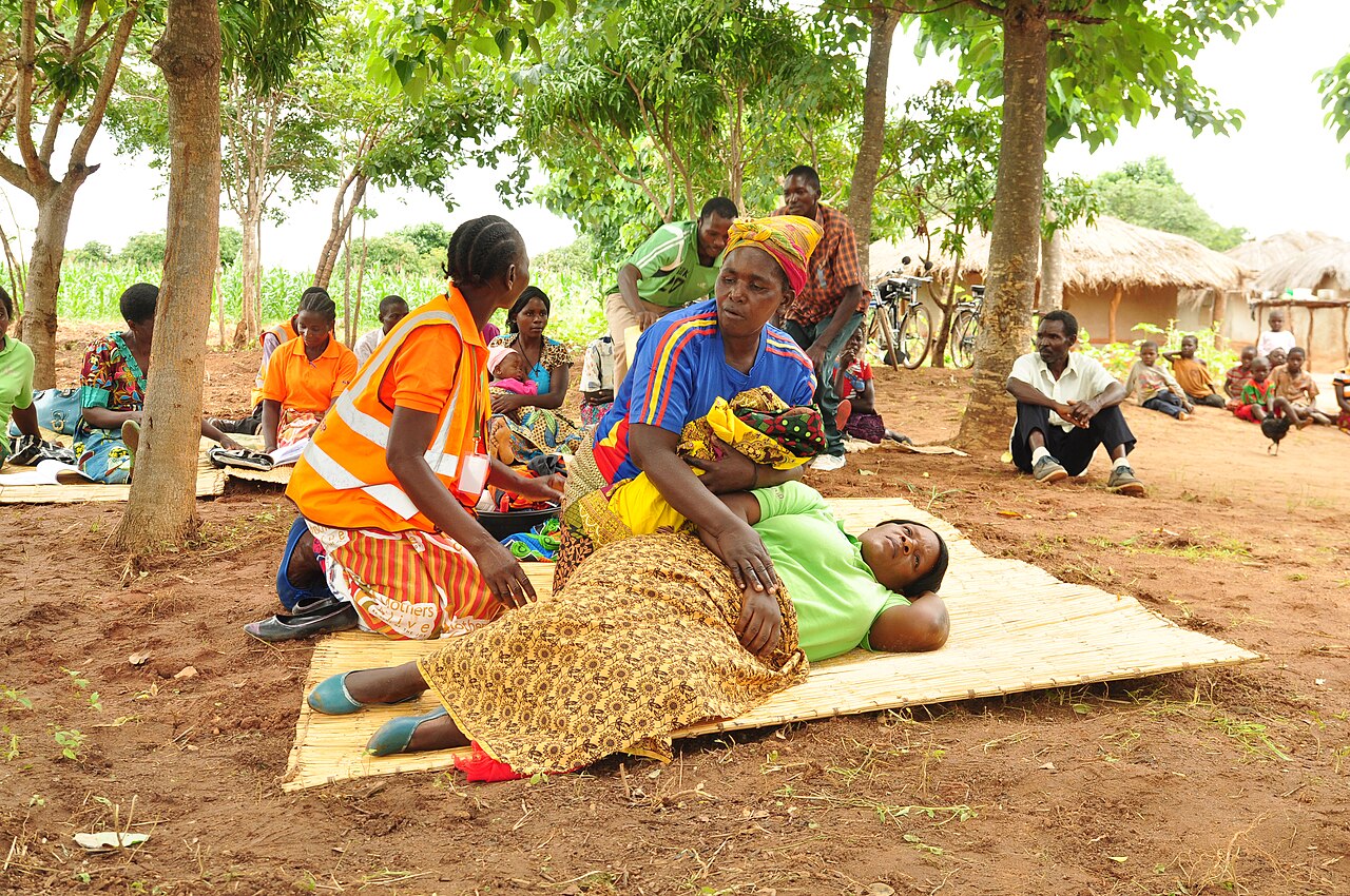 Field Enumerator Capturing Beneficiary Data and Aid Verifications on Mobile Tablet