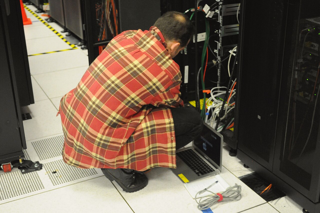 Systems Engineer Patching Server Racks in Enterprise Data Center